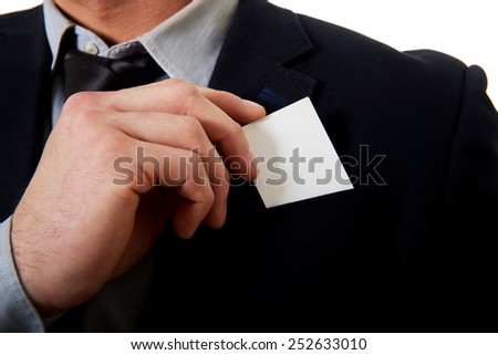 Young businessman taking his personal card from pocket.