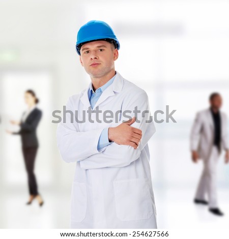 Man in a lab coat and helmet, engineer, teacher or chemical