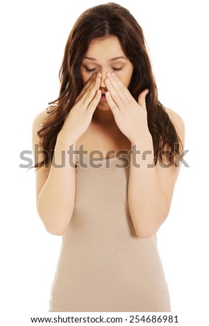 Young woman suffering from sinus pressure pain.