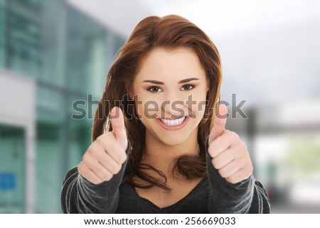 Happy smiling woman with thumbs up