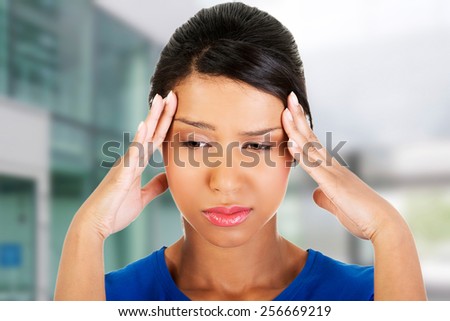 Young woman with huge head ache