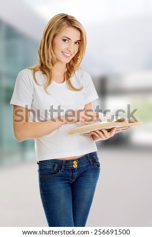 Student woman with book in hand