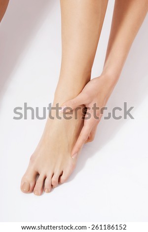 Close up on woman touching her foot bone.