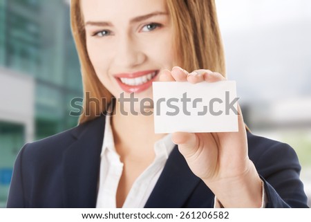 Beautiful caucasian business woman holding small personal card.