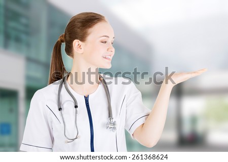 Medical doctor woman presenting and showing copy space.