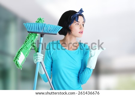 Happy cleaning woman showing copy space