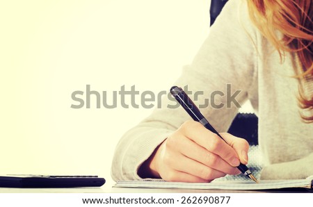 Handwriting, hand  writes with a pen in a notebook