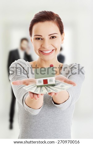 Happy smiling woman with us money and house.
