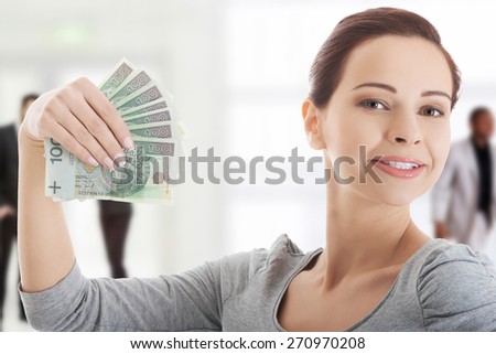 Happy smiling woman with polish money.