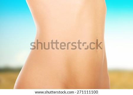 Beautiful slim female naked belly.