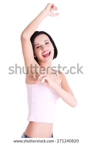 Young happy woman shaving armpit.