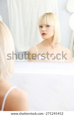 Beautiful woman viewing herself in the mirror.