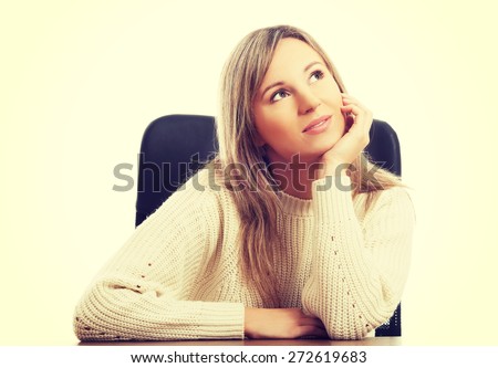 Young beautiful woman sitting at work
