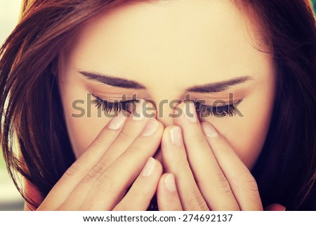 Young woman with sinus pressure pain