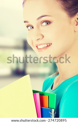 Happy student woman with notebooks