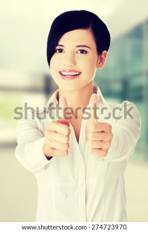 Happy smiling woman thumbs up