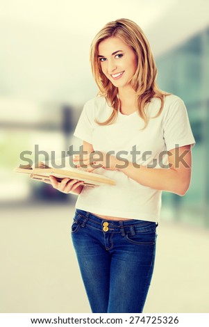 Student woman with book in hand
