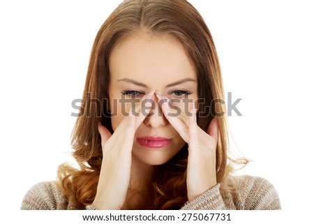 Woman suffering from sinus pressure pain.