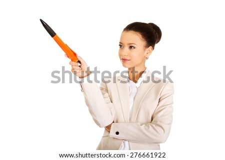 African businesswoman pointing up with big pen.