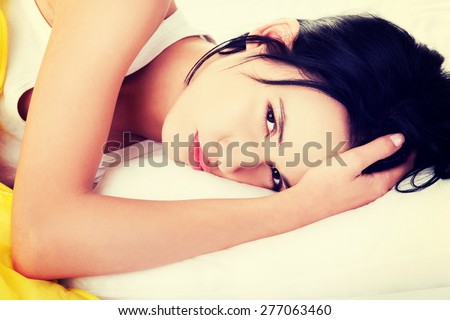 Young lazy woman lying in bed.
