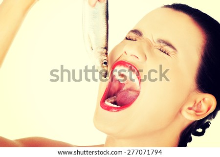 Close up woman eating raw fish.