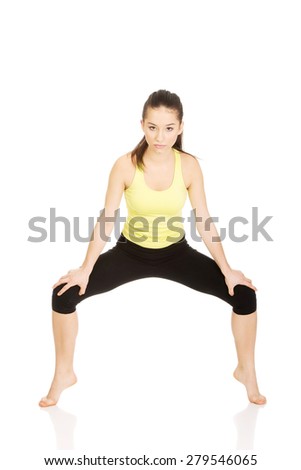 Young fitness woman in warm up exercise.