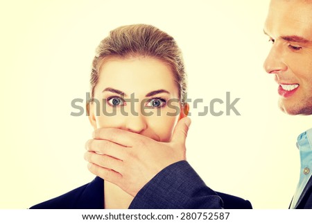 Young man covering woman\'s mouth