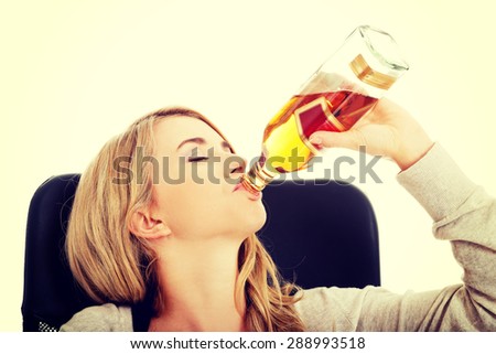 Yound beautiful woman in depression, drinking alcohol