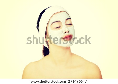 Relaxed woman with  a deep cleansing nourishing face mask applied to her face, beauty and skincare concept