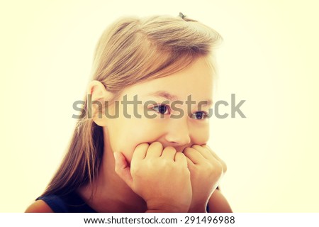 Scared little girl biting her nails
