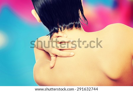 Slim nude woman with back pain