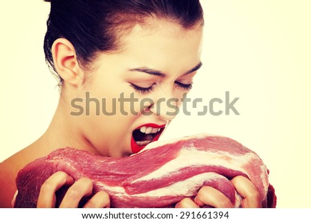 Young naked woman eating pork