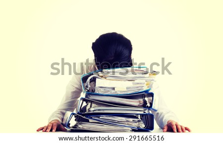 Exhausted businesswoman with a lot of documents