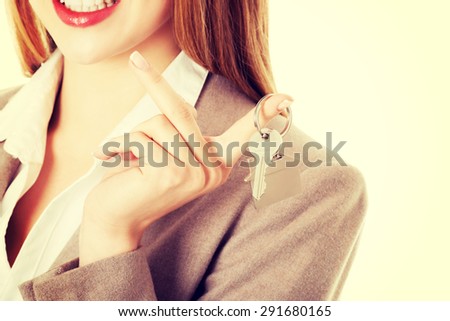 Happy woman agent holding the keys