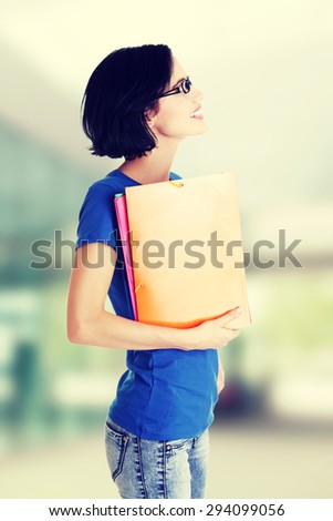 Happy student woman with notebooks.