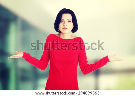 Young female gesturing do not know sign.
