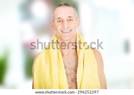 Smiling mature man with a towel around neck.