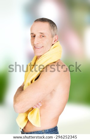 Smiling mature man with a towel around neck.