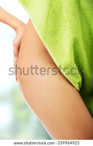 Spa woman wrapped in towel showing her thigh