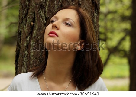 Beautiful young woman outdoors forest portrait