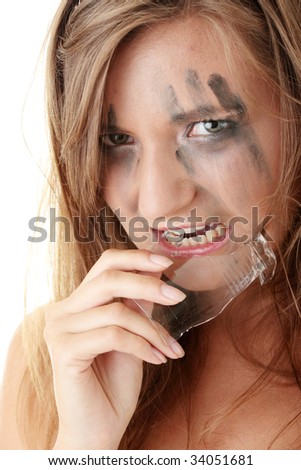 Angry dangerous princess in white dress eating a broken glass - horror concept