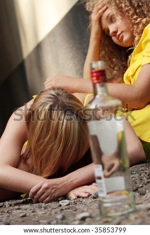 Teen alcohol addiction (drunk teens with vodka bottle)