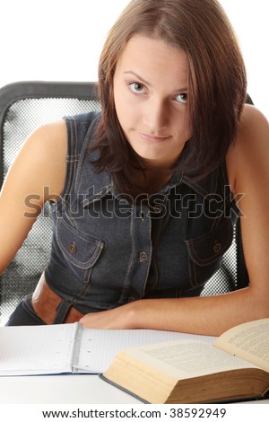 High school or college female student sitting by the desk, reading book and making notes in notepad. Isolated on white background