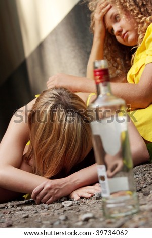 Teen alcohol addiction (drunk teens with vodka bottle)