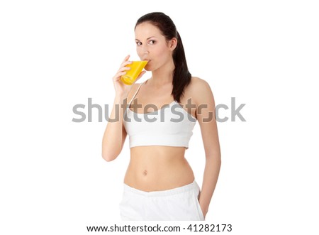 Young beautiful fit caucasian woman drinking orange juice from glass, isolated on white background