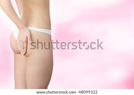 Closeup of young woman with hand on her buttock