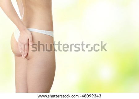 Closeup of young woman with hand on her buttock