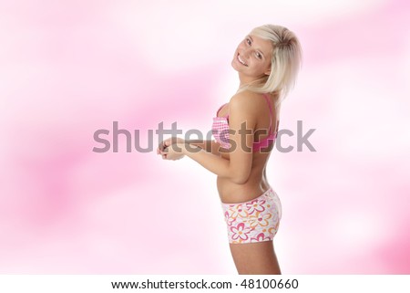 Beautiful and sexy Caucasian woman in pink underwear over pink background