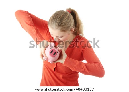 Young blond woman trying to get money from her piggy bank, isolated on white background