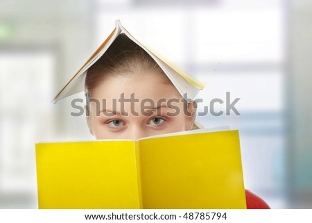 Young student woman with books all over her body